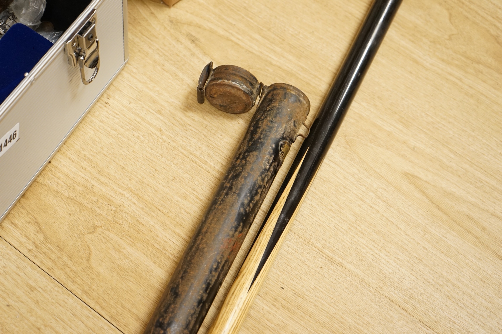A collection of tribal spears, a fish hook, a cased snooker cue, etc.